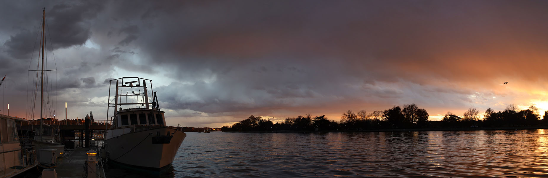 Panorama of Boat at Dock and Water at Sunset.